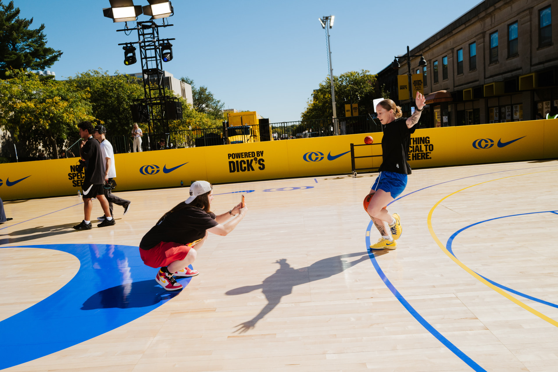 Hannah Mortimer playing basketball on an outdoor court at a brand activation